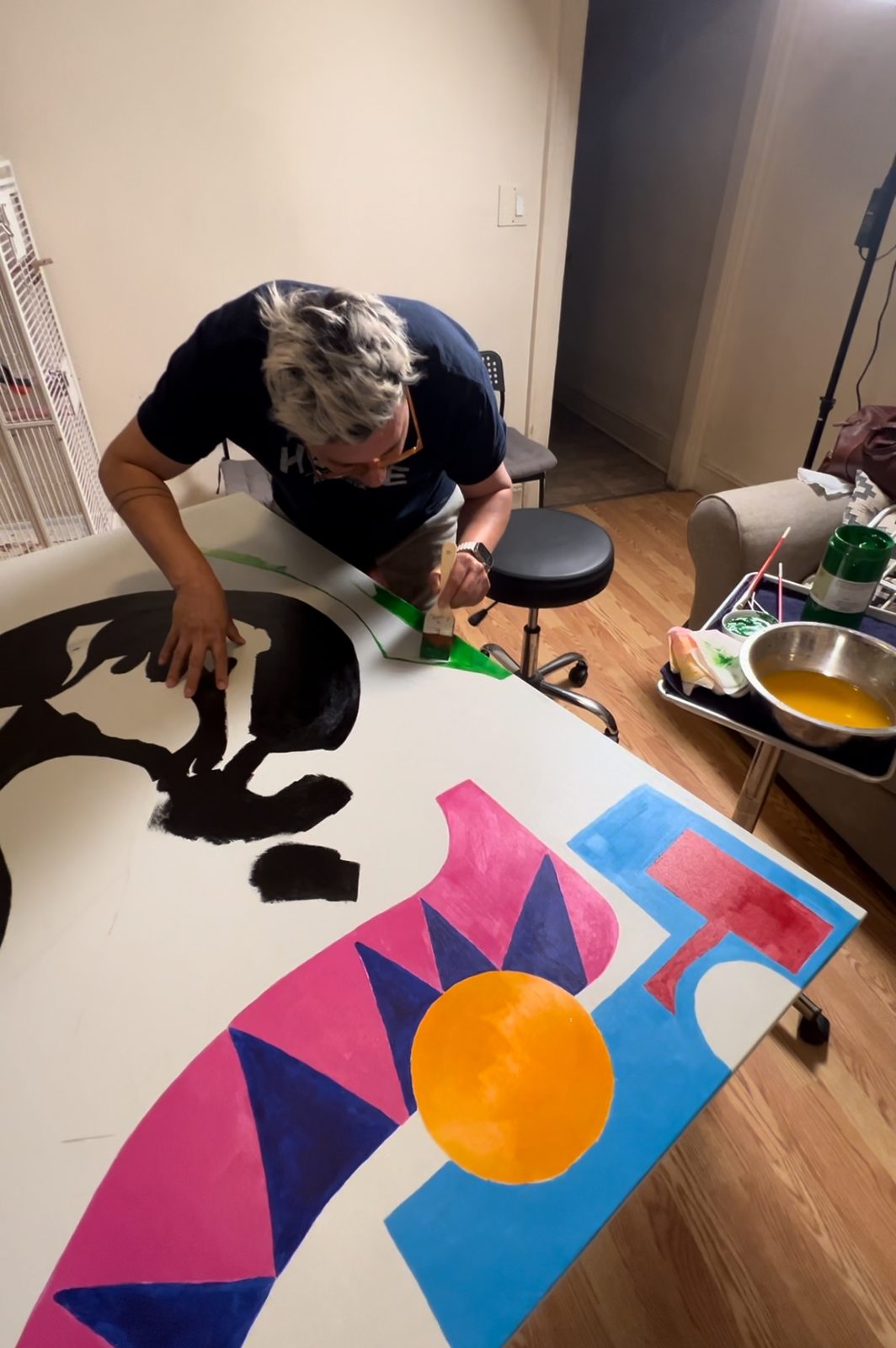 Tony painting black shapes on a canvas