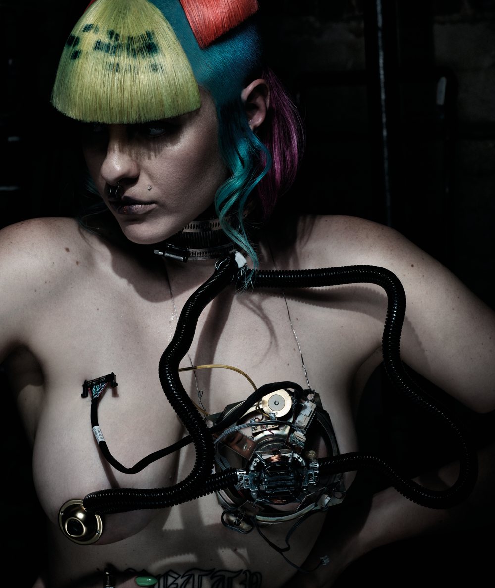 A model with black tubes and a metal piece over her chest