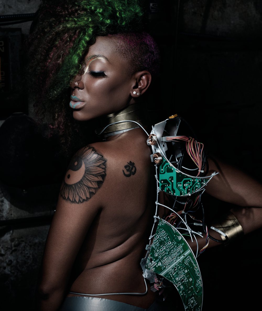 A model seen from behind, with green circuits over her shoulder